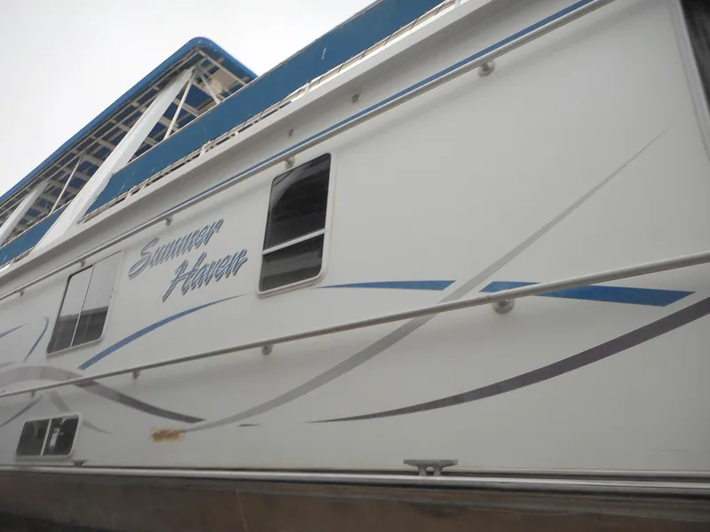 Slide: The Image of 2003 Stardust Cruisers Summer Haven Trip 33 houseboat side view with window and logo. - 35