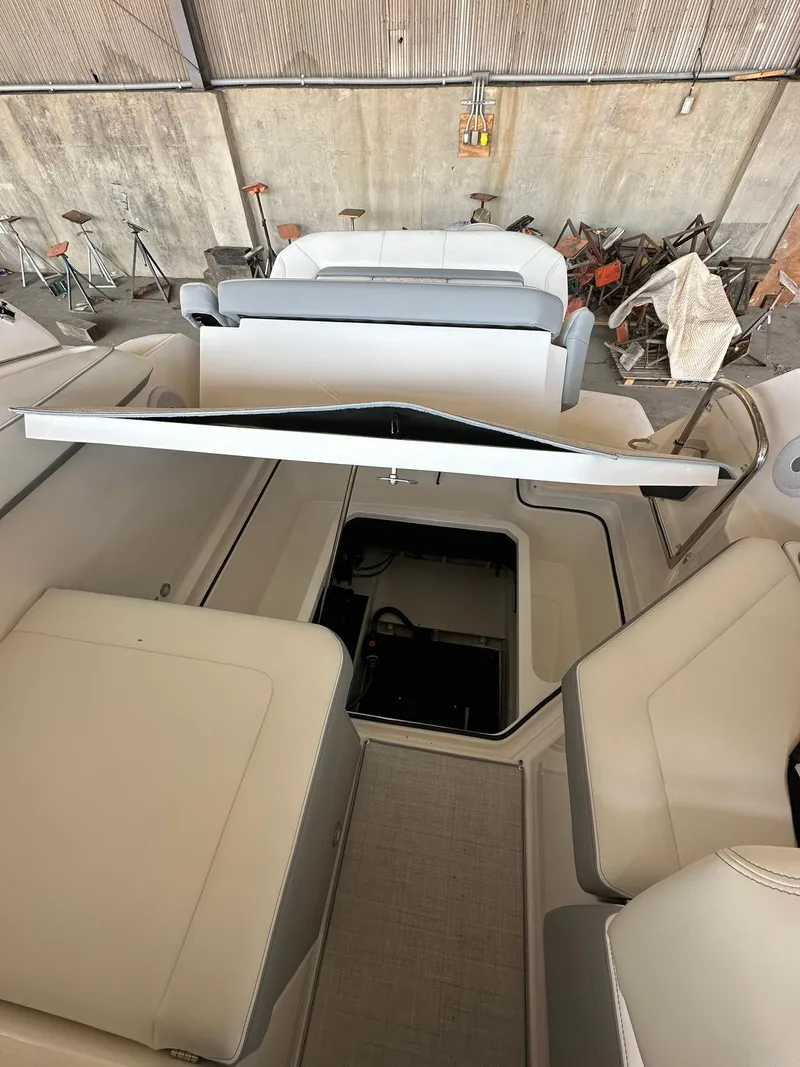 Slide: The Image of 2025 Regal 26XO boat interior with cushioned seating in a storage area. - 10