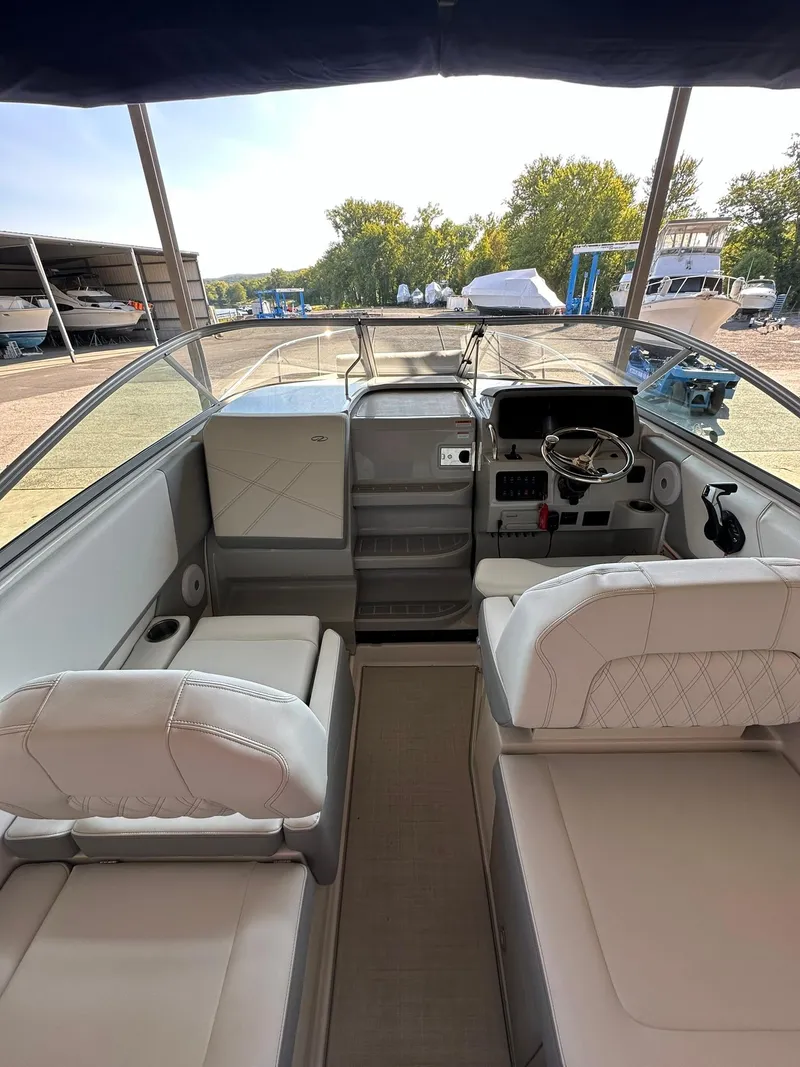 Slide: The Image of 2025 Regal 26XO boat interior with open storage compartments and modern seating. - 15