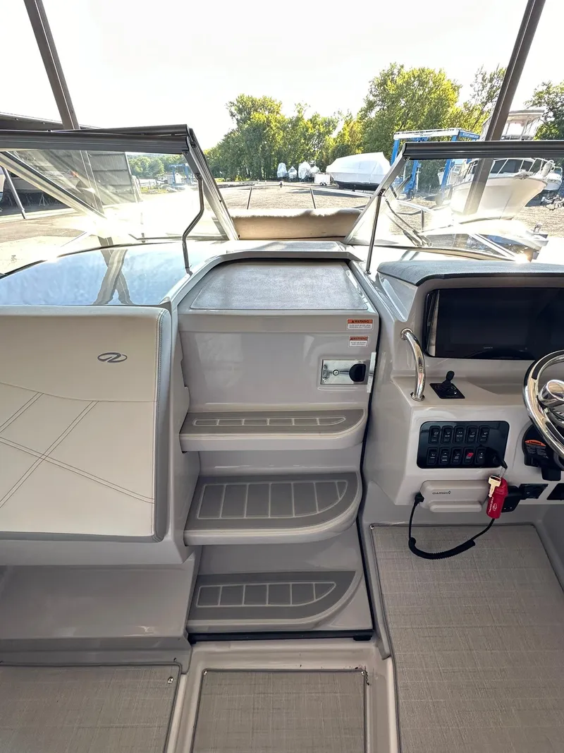 Slide: The Image of 2025 Regal 26XO boat helm with steering wheel and control panel. - 20