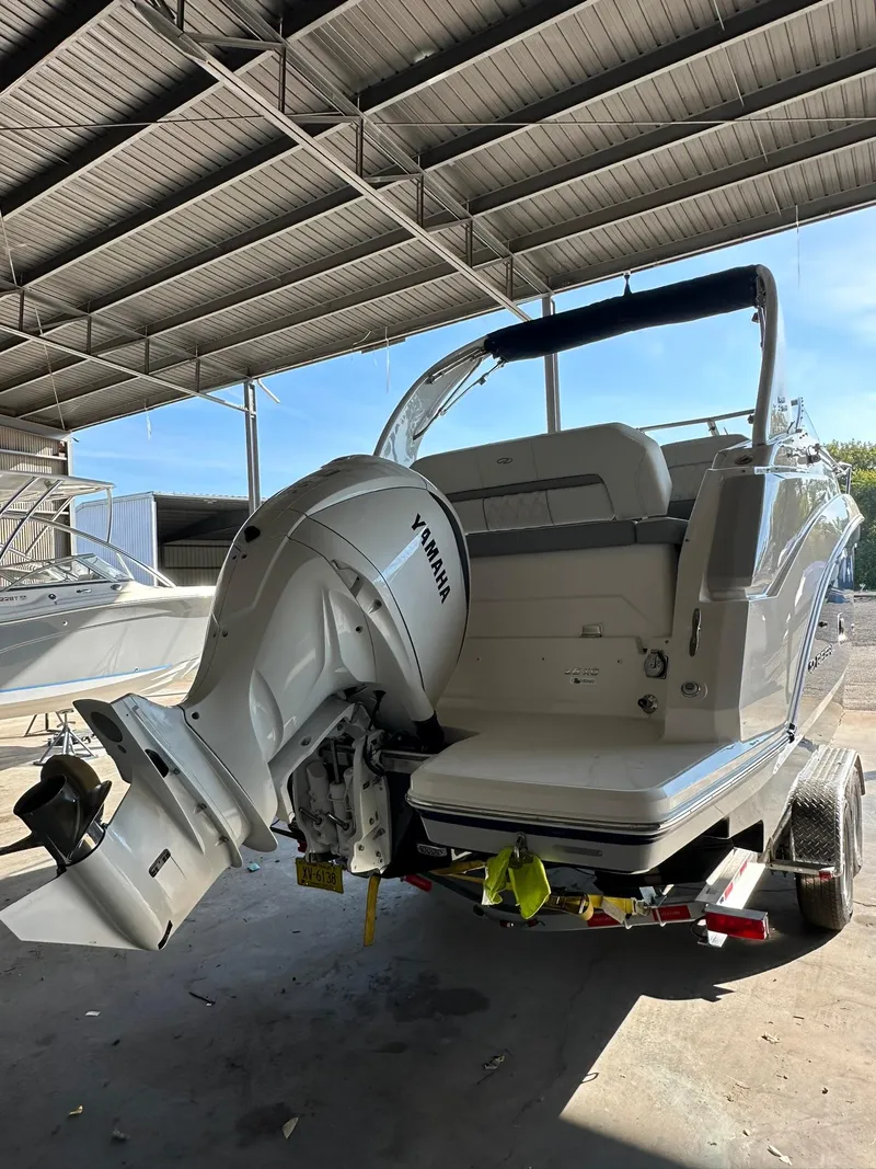 Slide: The Image of 2025 Regal 26XO boat with outboard motor in covered storage. - 3