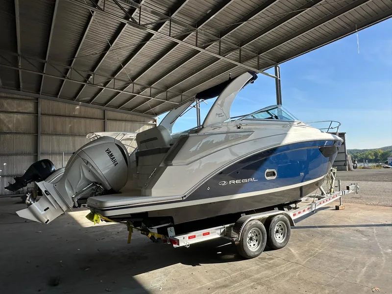 Slide: The Image of 2025 Regal 26XO boat with Yamaha outboard engine in covered storage. - 4