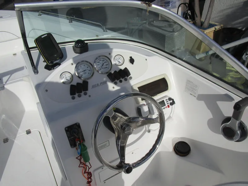 Slide: The Image of 2006 Sea Pro 206 Dual Console boat dashboard with steering wheel and gauges. - 15
