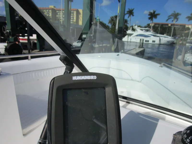 Slide: The Image of Humminbird device on 2006 Sea Pro 206 Dual Console boat, marina background. - 16