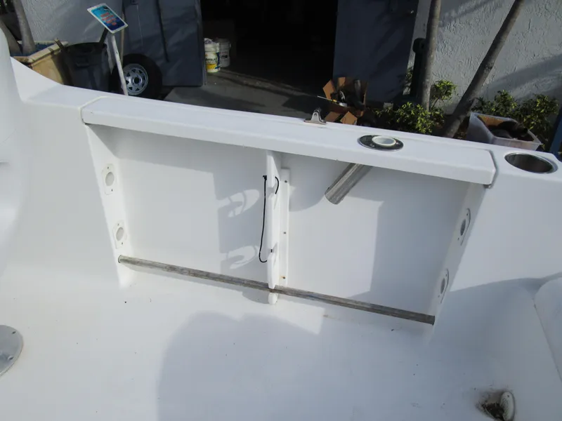 Slide: The Image of 2006 Sea Pro 206 Dual Console boat interior with storage compartment and rod holders. - 21