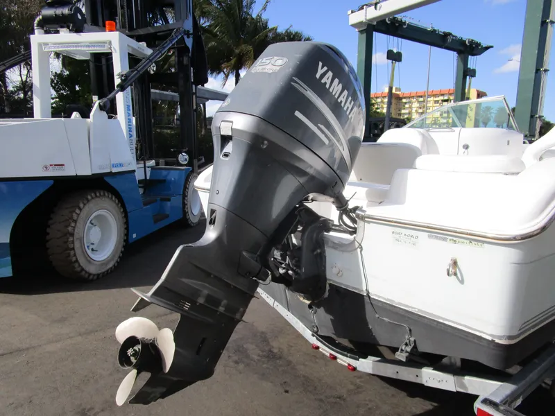 Slide: The Image of 2006 Sea Pro 206 Dual Console with Yamaha outboard motor, docked near a forklift. - 25