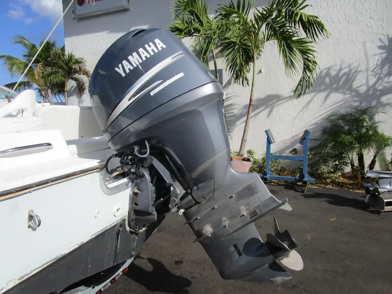 Slide: The Image of Yamaha outboard motor on 2006 Sea Pro 206 Dual Console boat, parked near palm trees. - 26
