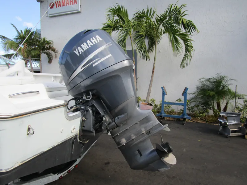 Slide: The Image of Yamaha outboard motor on 2006 Sea Pro 206 Dual Console boat, parked near palm trees. - 3