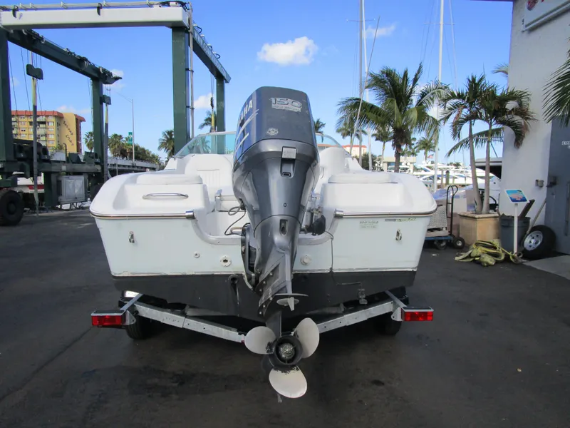 Slide: The Image of 2006 Sea Pro 206 Dual Console boat with outboard motor, docked near palm trees. - 6