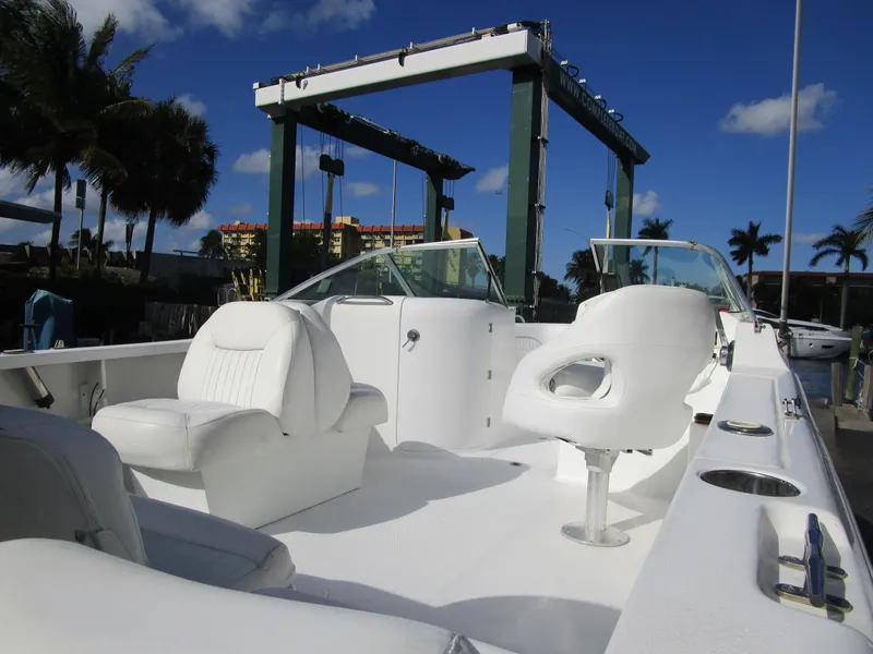 Slide: The Image of 2006 Sea Pro 206 Dual Console boat with white seating, docked under clear blue sky. - 7