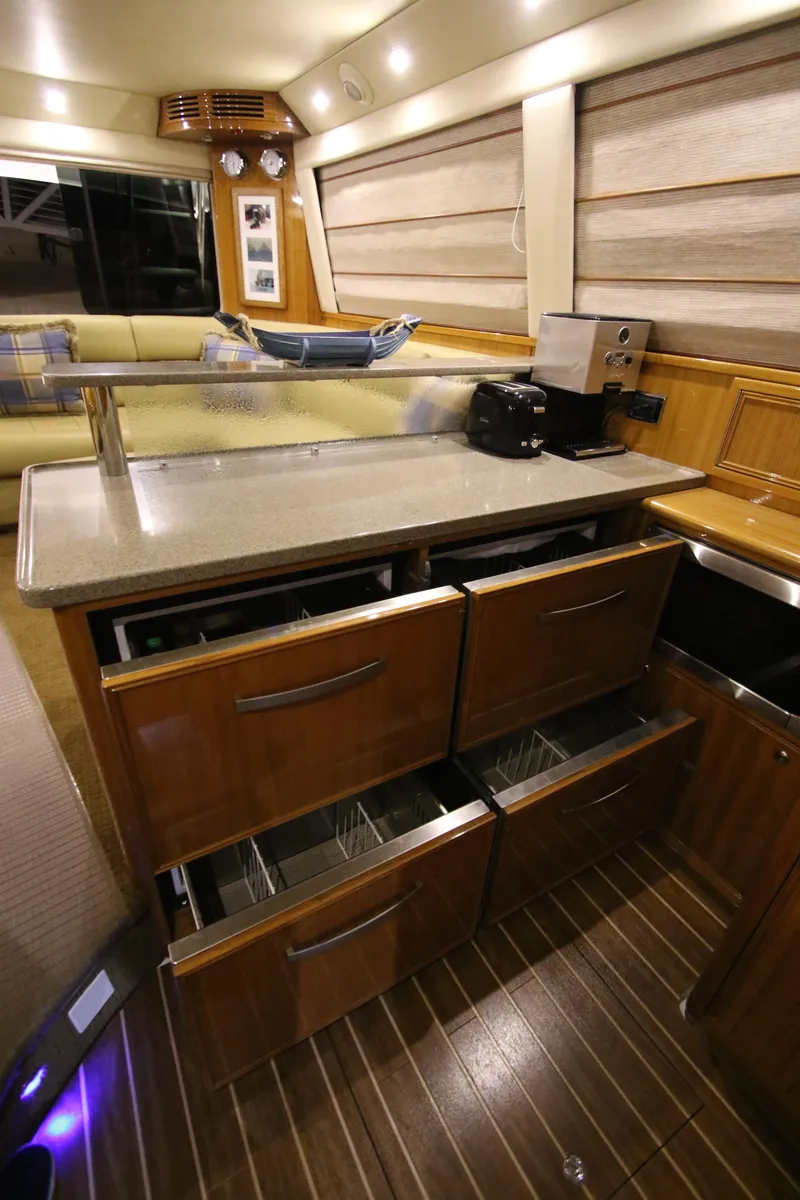 Slide: The Image of Interior of 2008 Riviera 47 Open Flybridge Series II with wooden cabinetry and drawers. - 12