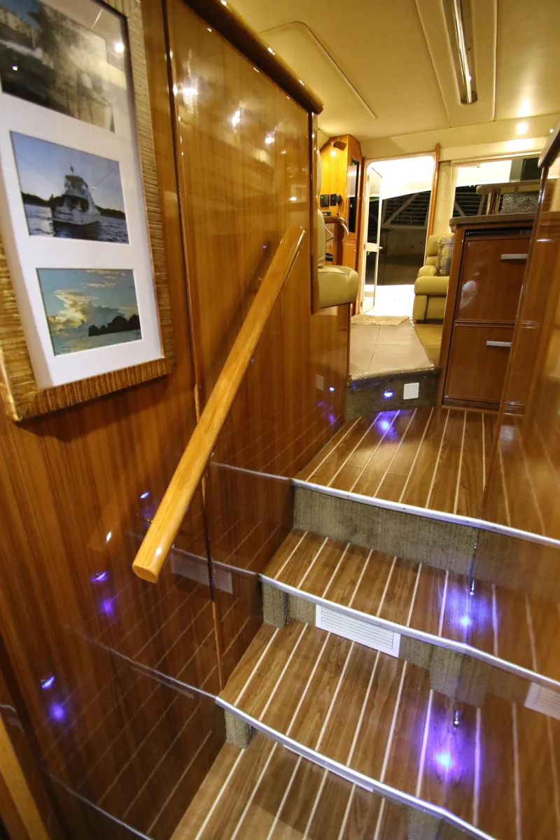 Slide: The Image of Interior of Riviera 47 Open Flybridge Series II, stairs with wooden walls. - 19