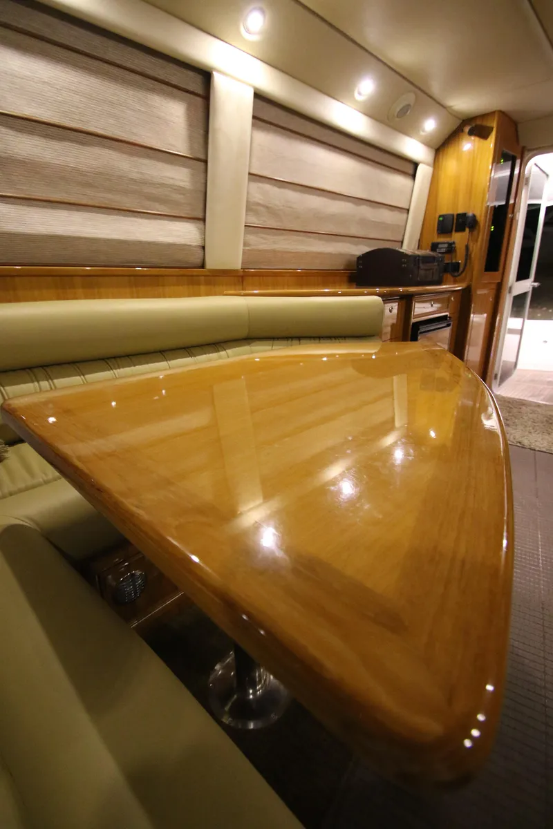 Slide: The Image of Interior of 2008 Riviera 47 Open Flybridge Series II with elegant wooden table. - 8