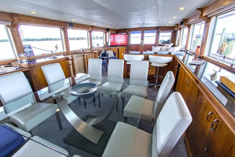 Slide: The Image of Luxurious interior of 1983 Benetti Custom Lloyds M.Y. yacht with modern dining area. - 31