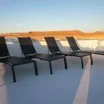 Slide: The Image of Five black lounge chairs on a boat deck at sunset, Bravada Knot A Problem 2011. - 16