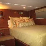 Slide: The Image of Cozy bedroom in 2011 Bravada Knot A Problem houseboat with warm lighting and decorative pillows. - 7