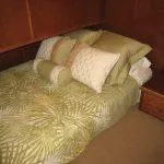 Slide: The Image of Cozy bed with green leaf-patterned bedding in Bravada Knot A Problem houseboat. - 8