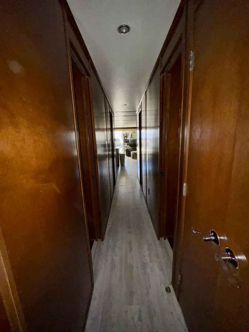Slide: The Image of Narrow hallway inside 2013 Bravada Bella Luna Share #8, featuring wooden doors and flooring. - 21