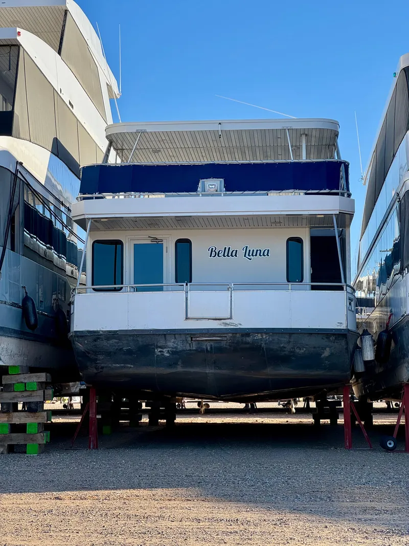 Slide: The Image of 2013 Bravada Bella Luna Share #8 houseboat on dry dock, surrounded by other boats. - 30