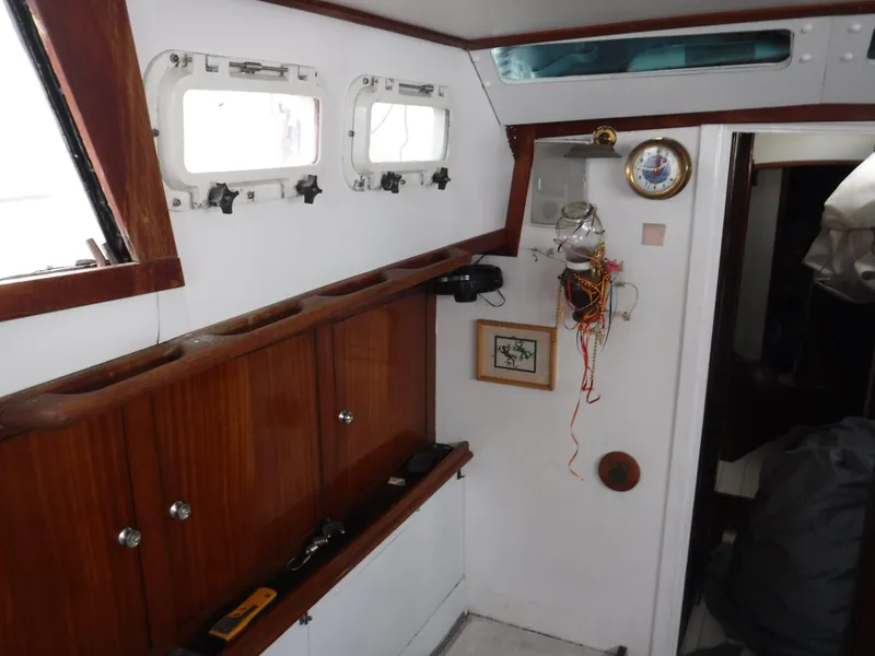 Slide: The Image of Interior of 1960 Frans Maas-LeFevre One Off Custom 47 sailboat, featuring wooden cabinets and nautical decor. - 13