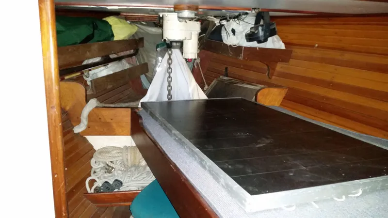 Slide: The Image of Interior of 1960 Frans Maas-LeFevre One Off Custom 47 sailboat, featuring wooden paneling and storage. - 15