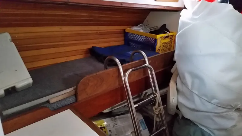 Slide: The Image of Interior of a 1960 Frans Maas-LeFevre One Off Custom 47 sailboat, featuring storage and ladder. - 16