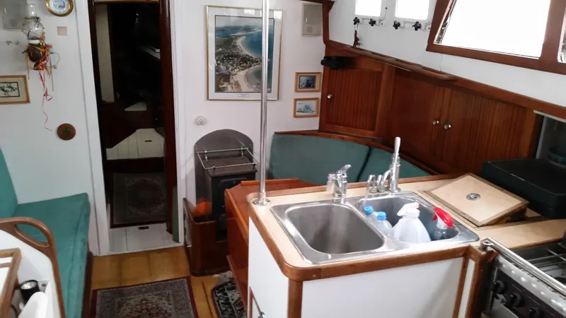 Slide: The Image of Interior of 1960 Frans Maas-LeFevre One Off Custom 47 yacht, featuring kitchen and seating area. - 2