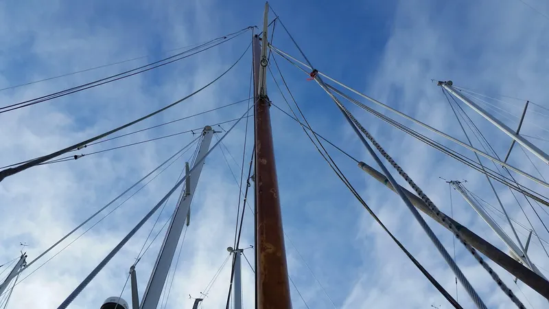 Slide: The Image of Masts and rigging of a 1960 Frans Maas-LeFevre One Off Custom 47 sailboat against blue sky. - 34