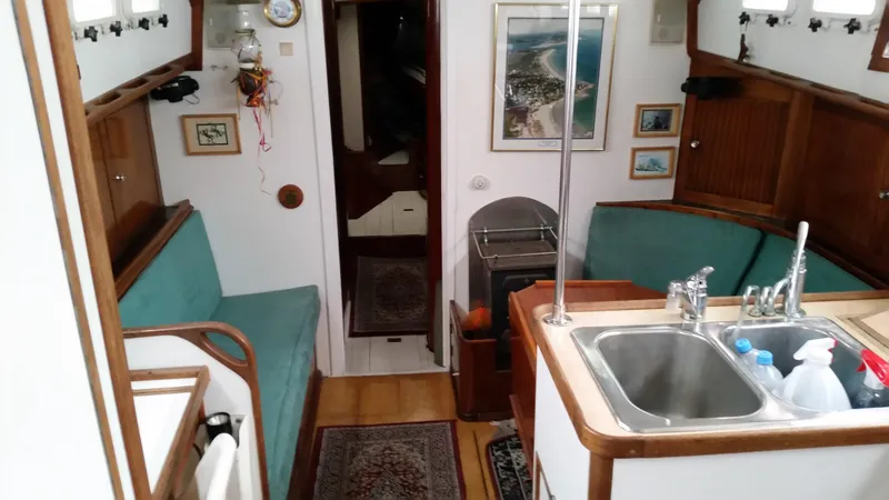 Slide: The Image of Interior of 1960 Frans Maas-LeFevre One Off Custom 47 yacht, featuring cozy seating and kitchen area. - 5