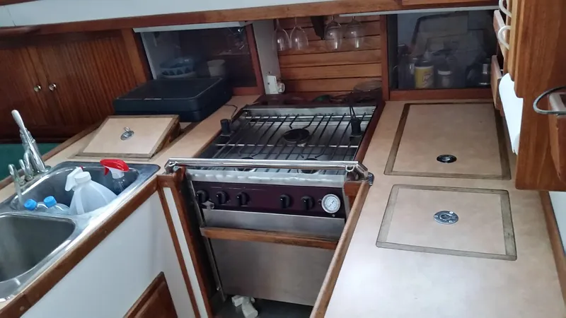 Slide: The Image of 1960 Frans Maas-LeFevre yacht kitchen with stove, sink, and wooden cabinetry. - 6