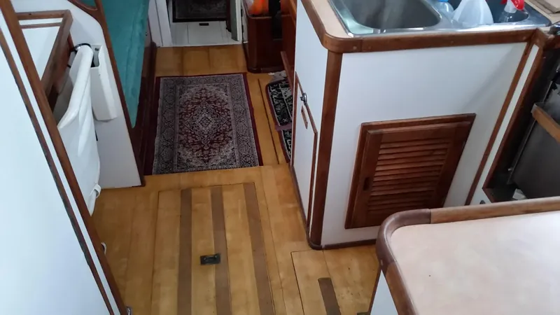Slide: The Image of Interior of 1960 Frans Maas-LeFevre One Off Custom 47 yacht, featuring wood flooring and compact kitchen. - 9