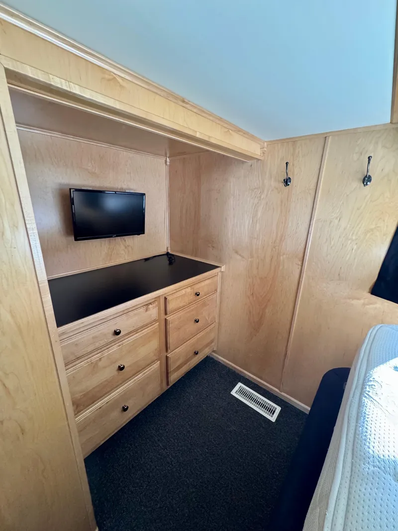 Slide: The Image of 2006 Sumerset Seas The Day Trip 11 cabin with TV, wooden drawers, and hooks. - 20