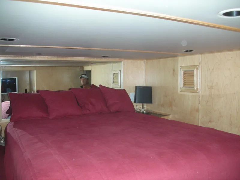 Slide: The Image of Sumerset Seas The Day Trip 11 2006 houseboat bedroom with red bedding and wooden walls. - 3