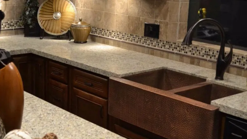 Slide: The Image of Luxurious kitchen with granite countertops, copper sink, and elegant tile backsplash. - 6