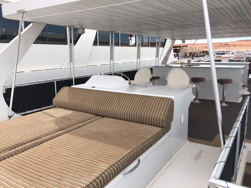 Slide: The Image of 2012 Bravada Ho'okipa Trip 13 yacht with striped seating and covered deck area. - 8