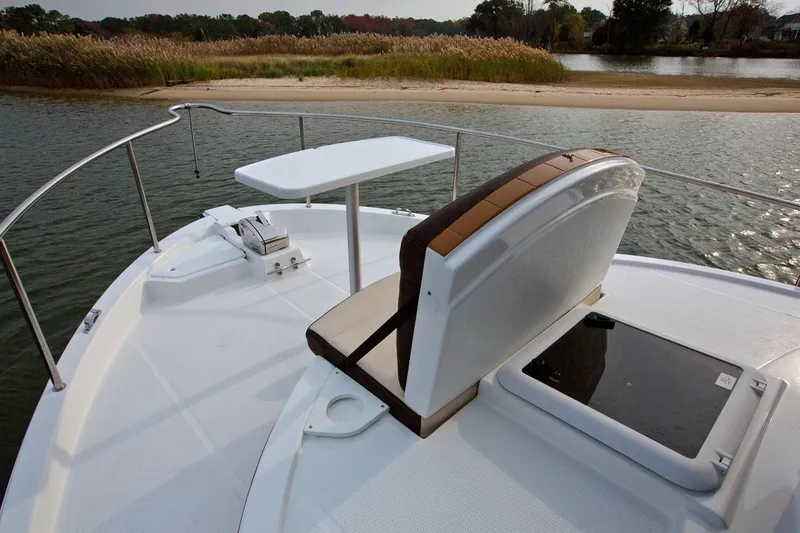 Slide: The Image of 2024 Ranger Tugs R-31 Sedan Luxury Edition boat bow with seating and table. - 16