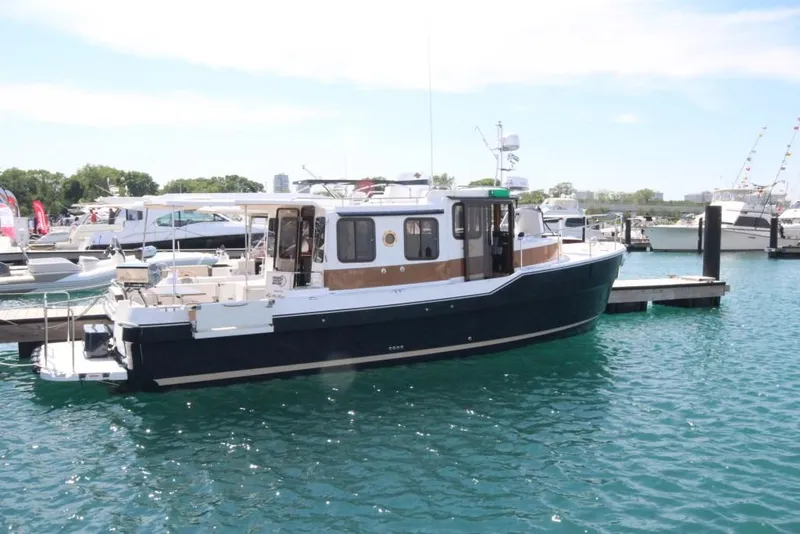 Slide: The Image of 2024 Ranger Tugs R-31 Sedan Luxury Edition docked in a marina. - 34