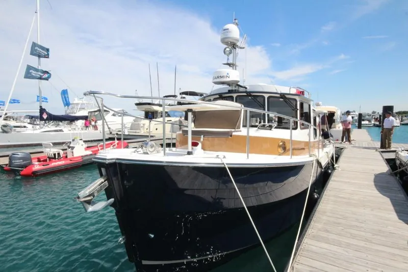 Slide: The Image of 2024 Ranger Tugs R-31 Sedan Luxury Edition docked at marina. - 36