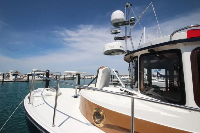 Slide: The Image of 2024 Ranger Tugs R-31 Sedan Luxury Edition docked at a marina. - 39