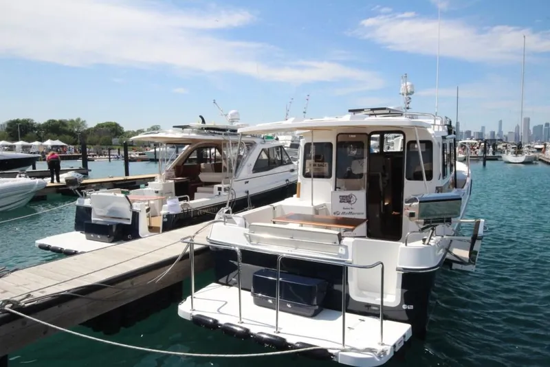 Slide: The Image of 2024 Ranger Tugs R-31 Sedan Luxury Edition docked at marina. - 40