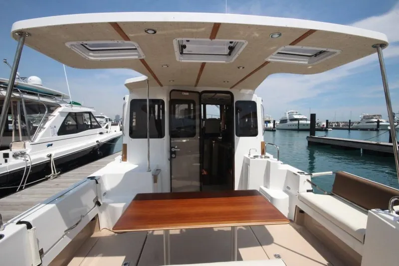 Slide: The Image of 2024 Ranger Tugs R-31 Sedan Luxury Edition boat interior with table and seating. - 46
