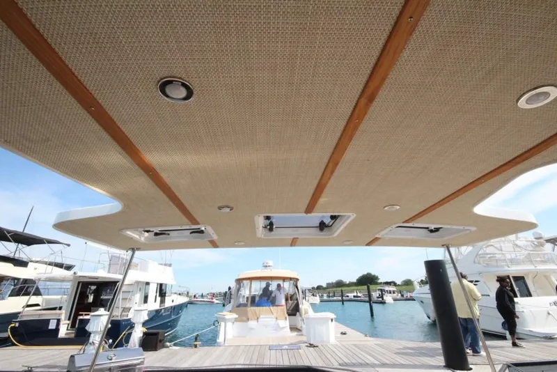 Slide: The Image of 2024 Ranger Tugs R-31 Sedan Luxury Edition at a marina dock. - 47