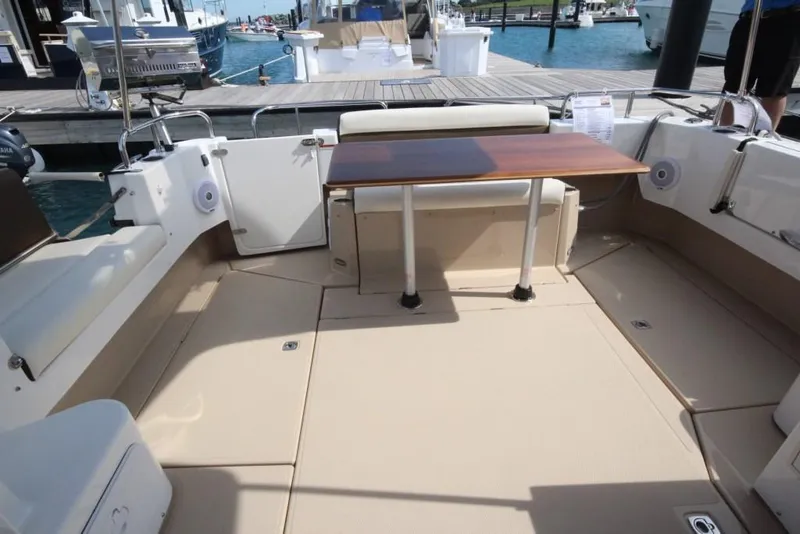 Slide: The Image of 2024 Ranger Tugs R-31 Sedan Luxury Edition boat interior with table and seating. - 49