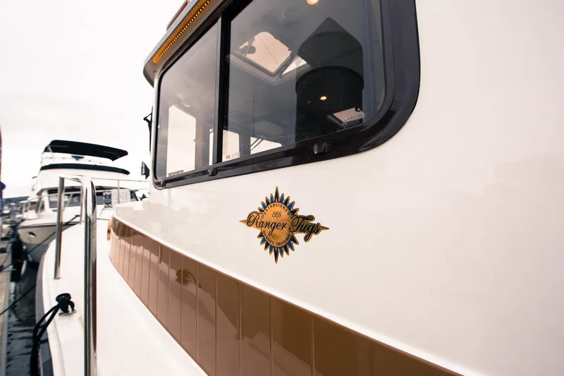 Slide: The Image of 2024 Ranger Tugs R-31 Sedan Luxury Edition boat docked at marina. - 8