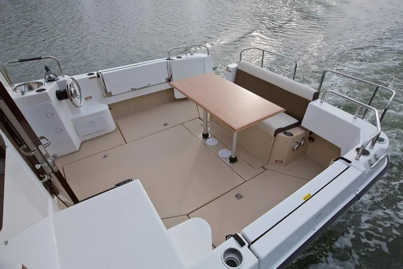 Slide: The Image of 2024 Ranger Tugs R-31 Sedan Luxury Edition boat deck with seating and table. - 14