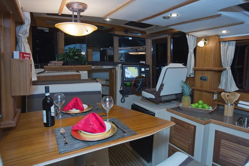 Slide: The Image of Interior of 2024 Ranger Tugs R-31 Sedan Luxury Edition with dining setup and helm station. - 19