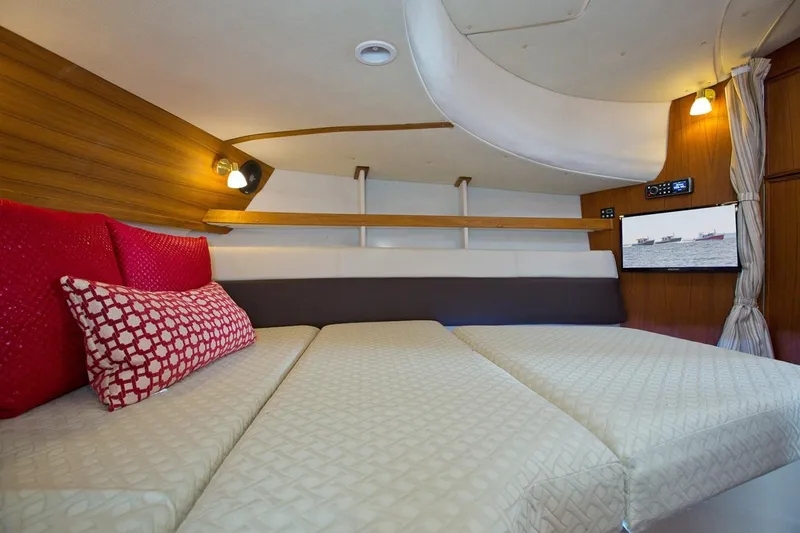 Slide: The Image of Luxurious cabin interior of 2024 Ranger Tugs R-31 Sedan Luxury Edition with cozy bedding. - 24