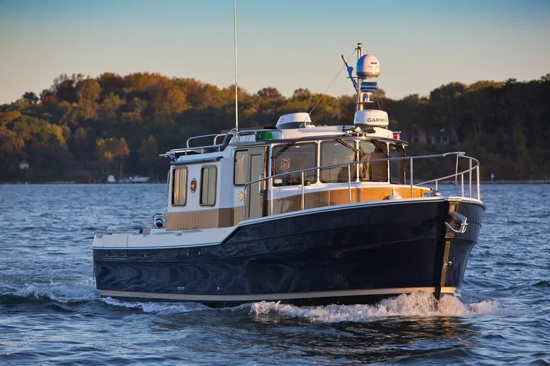 Slide: The Image of 2024 Ranger Tugs R-31 Sedan Luxury Edition cruising on a lake. - 29