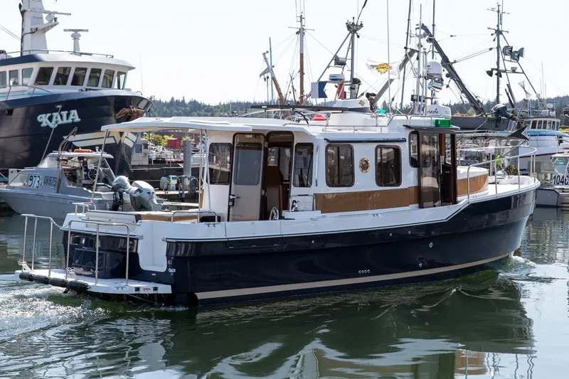 Slide: The Image of 2024 Ranger Tugs R-31 Sedan Luxury Edition in a marina. - 3