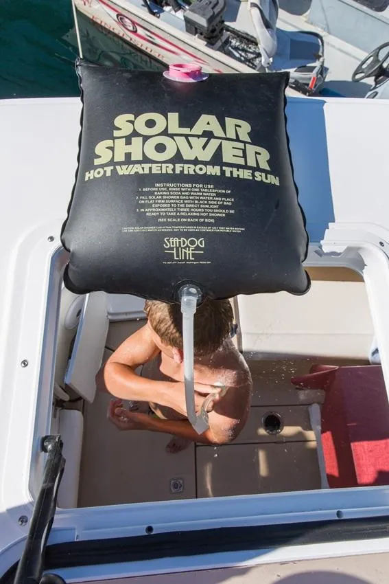 Slide: The Image of 2024 Ranger Tugs R-31 Sedan Luxury Edition with solar shower in use. - 32